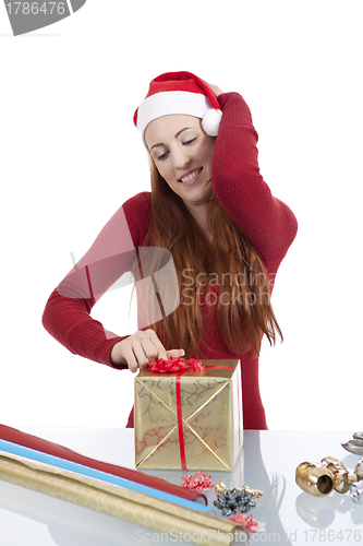 Image of young woman is packing  present for christmas isolated