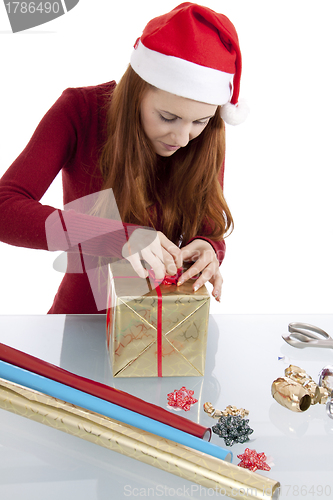 Image of young woman is packing  present for christmas isolated