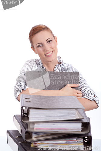 Image of business woman in office looks at unbelievable folder stack