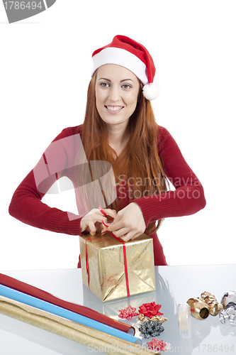 Image of young woman is packing  present for christmas isolated