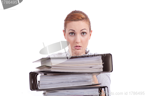 Image of business woman in office looks at unbelievable folder stack