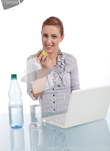 Image of young business woman on computer with snack isolated 