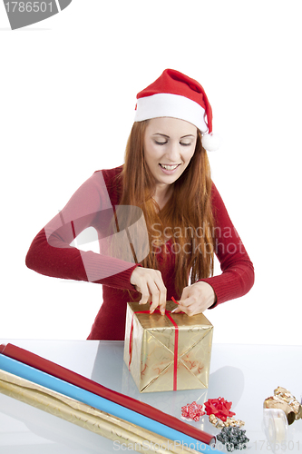 Image of young woman is packing  present for christmas isolated