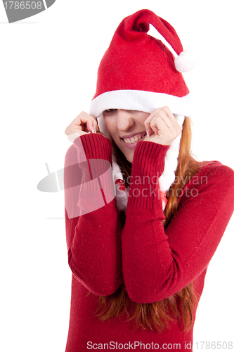 Image of smiling young woman at christmastime in red clothes isolated