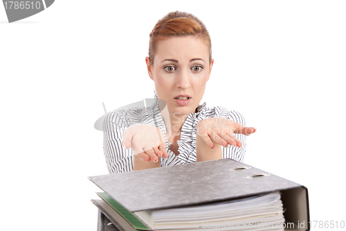 Image of business woman in office looks at unbelievable folder stack