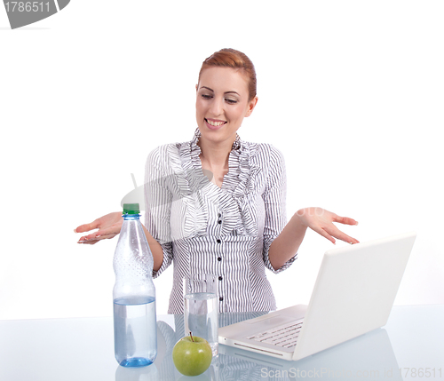 Image of young business woman on computer with snack isolated 