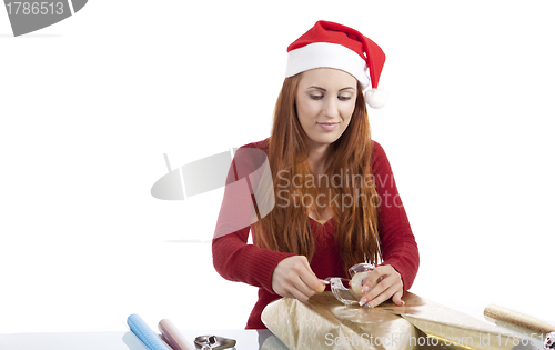 Image of young woman is packing  present for christmas isolated