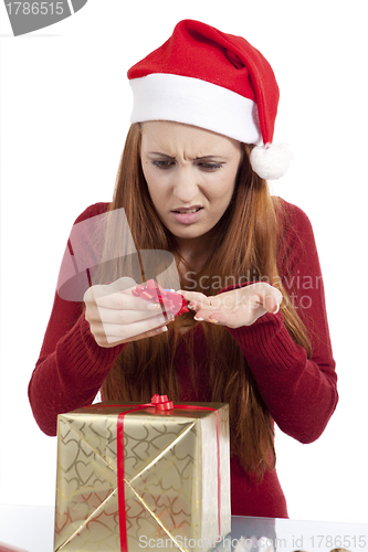 Image of young woman is packing  present for christmas isolated