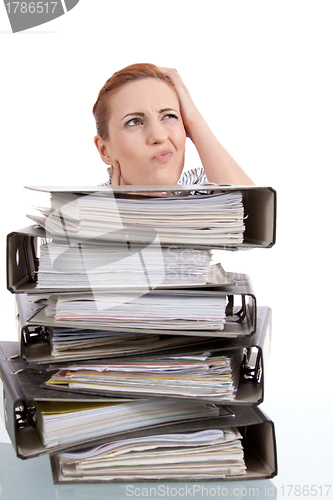 Image of business woman in office looks at unbelievable folder stack