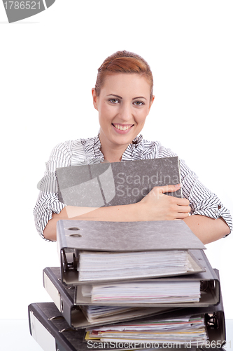 Image of business woman in office looks at unbelievable folder stack