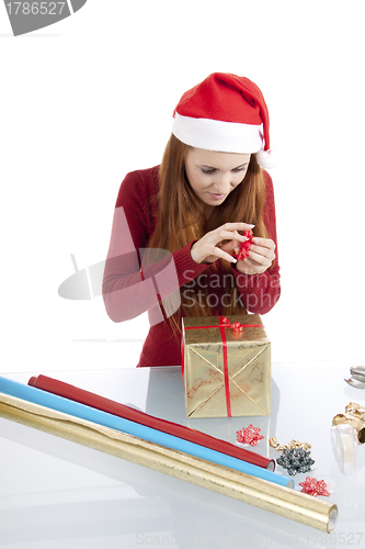 Image of young woman is packing  present for christmas isolated