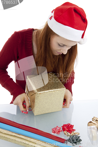 Image of young woman is packing  present for christmas isolated