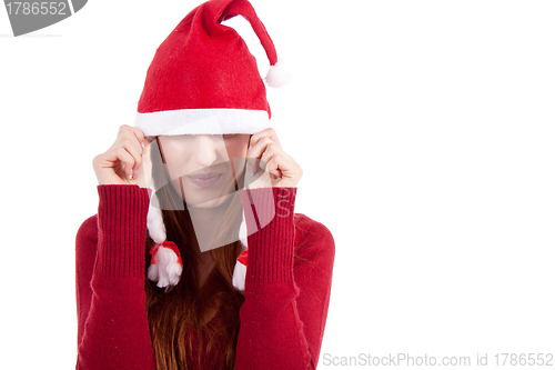 Image of smiling young woman at christmastime in red clothes isolated