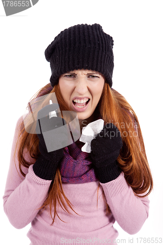 Image of woman with tissue and spray feels unwell with flu