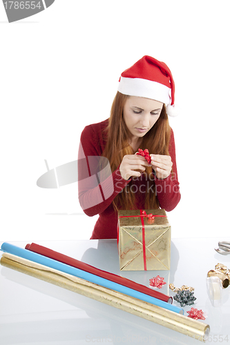 Image of young woman is packing  present for christmas isolated