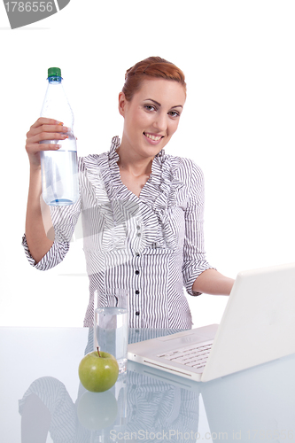 Image of young business woman on computer with snack isolated 