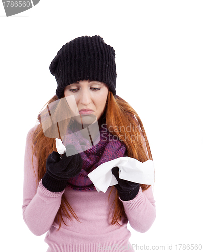 Image of woman with tissue and spray feels unwell with flu