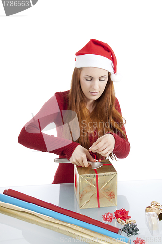 Image of young woman is packing  present for christmas isolated