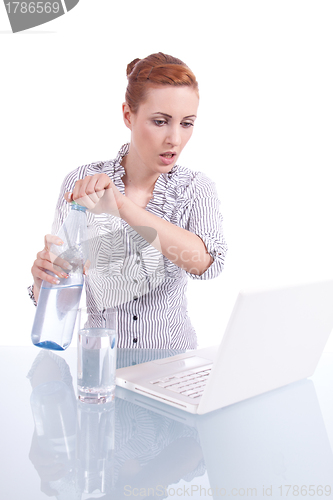 Image of young business woman on computer with snack isolated 