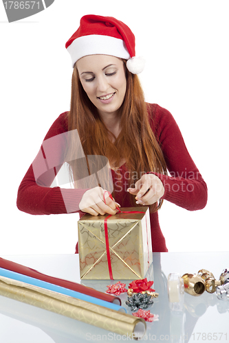 Image of young woman is packing  present for christmas isolated