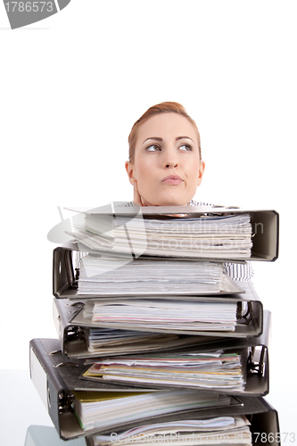 Image of business woman in office looks at unbelievable folder stack