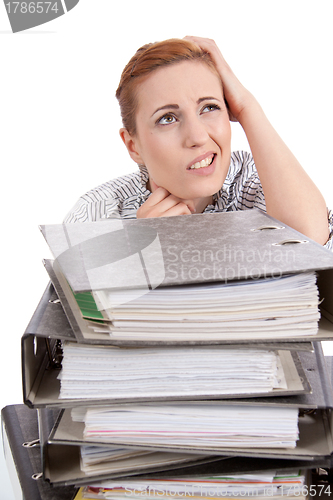 Image of business woman in office looks at unbelievable folder stack