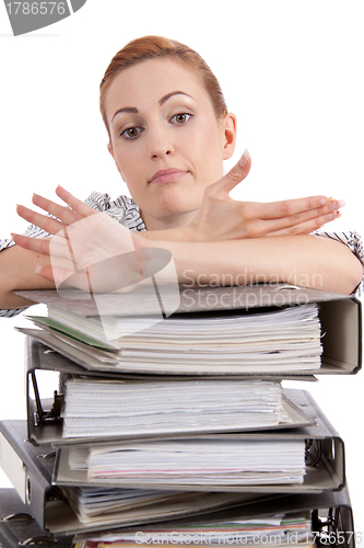 Image of business woman in office looks at unbelievable folder stack