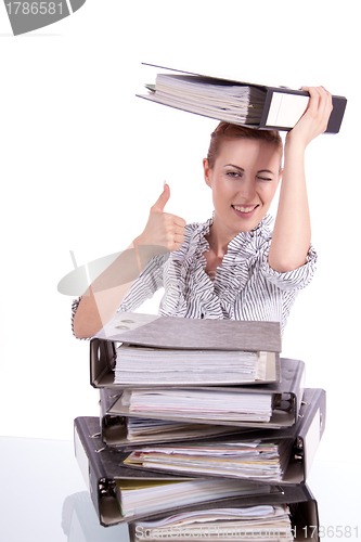 Image of business woman in office looks at unbelievable folder stack