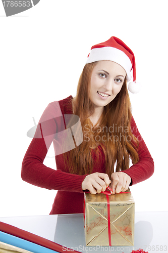 Image of young woman is packing  present for christmas isolated