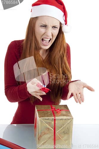 Image of young woman is packing  present for christmas isolated