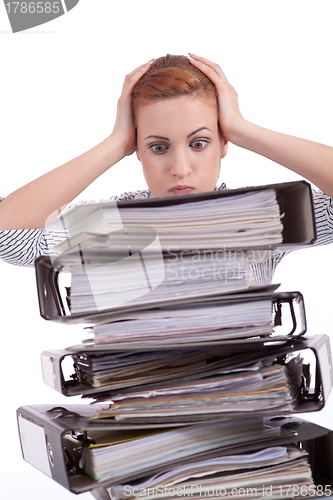 Image of business woman in office looks at unbelievable folder stack