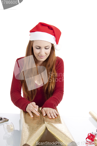 Image of young woman is packing  present for christmas isolated