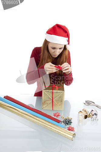 Image of young woman is packing  present for christmas isolated