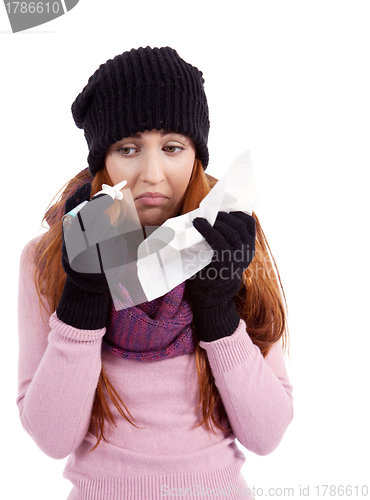 Image of woman with tissue and spray feels unwell with flu