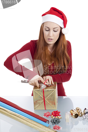 Image of young woman is packing  present for christmas isolated