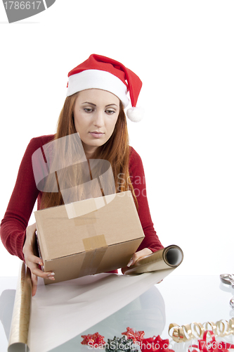 Image of young woman is packing  present for christmas isolated