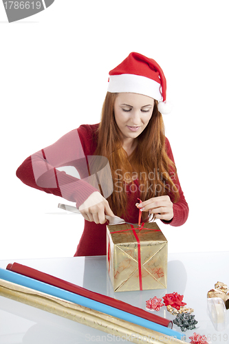 Image of young woman is packing  present for christmas isolated