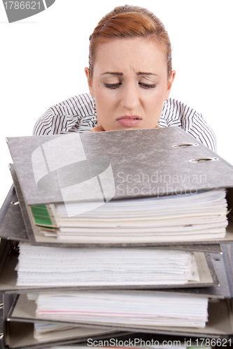 Image of business woman in office looks at unbelievable folder stack