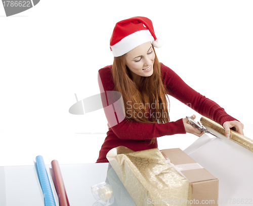 Image of young woman is packing  present for christmas isolated