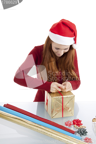 Image of young woman is packing  present for christmas isolated