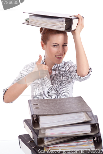 Image of business woman in office looks at unbelievable folder stack