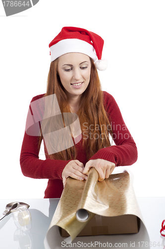 Image of young woman is packing  present for christmas isolated