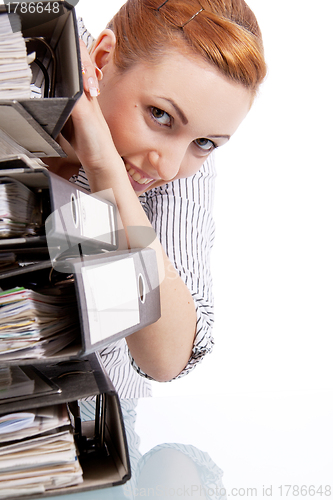 Image of business woman in office looks at unbelievable folder stack