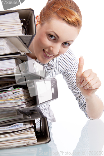 Image of business woman in office looks at unbelievable folder stack