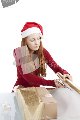 Image of young woman is packing  present for christmas isolated