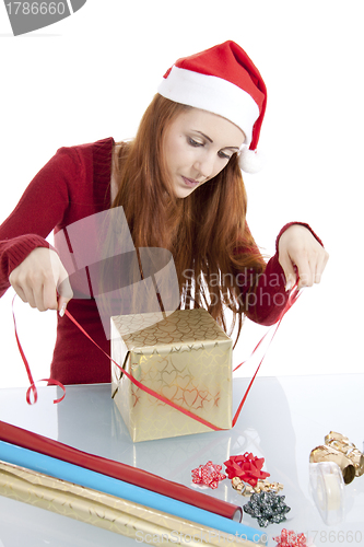 Image of young woman is packing  present for christmas isolated