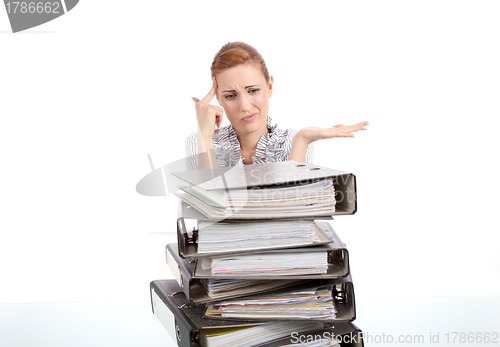 Image of business woman in office looks at unbelievable folder stack