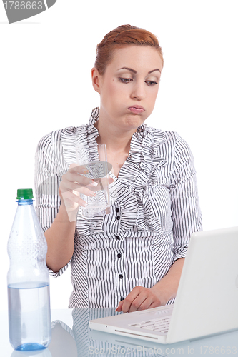 Image of young business woman on computer with snack isolated 