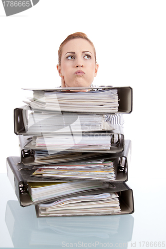 Image of business woman in office looks at unbelievable folder stack