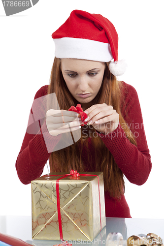 Image of young woman is packing  present for christmas isolated